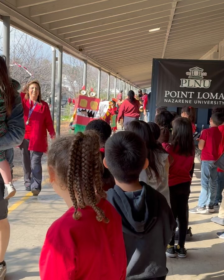 Baldy View students and staff celebrating Lunar New Year as a colorful dragon moves through campus