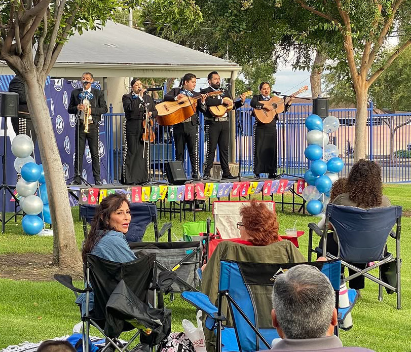 Baldy View families watching a mariachi ensemble perform on the school lawn